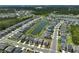 Aerial view showcasing a well-planned community with a central pond, lush landscaping, and neatly arranged homes at 4523 Birdsong Dr, Palmetto, FL 34221