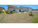 The open backyard has green grass, a small tree, and a patio set on a concrete patio at 4523 Birdsong Dr, Palmetto, FL 34221