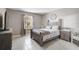 Cozy bedroom with a wooden-frame bed, side tables, and tiled floors, providing a calm retreat at 4523 Birdsong Dr, Palmetto, FL 34221