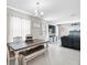 Open-concept dining area with a wooden table, bench seating, and view to the living room at 4523 Birdsong Dr, Palmetto, FL 34221