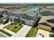 Charming two-story home with a manicured front lawn, complemented by a view of the nearby community pond at 4523 Birdsong Dr, Palmetto, FL 34221