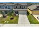 Inviting two-story home with a manicured lawn and meticulously landscaped garden beds at 4523 Birdsong Dr, Palmetto, FL 34221