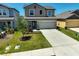 Beautiful two-story home with a well-manicured lawn and landscaped garden beds at 4523 Birdsong Dr, Palmetto, FL 34221