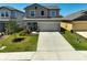 Charming two-story home with a well-maintained lawn and landscaped garden beds at 4523 Birdsong Dr, Palmetto, FL 34221