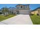 Charming two-story home featuring a well-manicured lawn and a spacious two car garage at 4523 Birdsong Dr, Palmetto, FL 34221