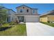Charming two-story home featuring a well-manicured lawn and a spacious two car garage at 4523 Birdsong Dr, Palmetto, FL 34221