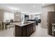 Bright and open kitchen featuring granite island, stainless appliances, and view to the living area at 4523 Birdsong Dr, Palmetto, FL 34221