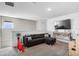 Upstairs living area, featuring a sectional sofa, mounted tv, and playroom at 4523 Birdsong Dr, Palmetto, FL 34221