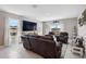Inviting living room featuring tile floors, a cozy sofa, and a flat screen tv for entertainment at 4523 Birdsong Dr, Palmetto, FL 34221