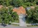 Aerial view of a well-maintained home with a tile roof, surrounded by mature trees at 4885 Tamarack Trl, Venice, FL 34293