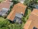 Aerial view of a home with a screen enclosed lanai surrounded by lush green landscape at 4885 Tamarack Trl, Venice, FL 34293