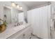 Clean bathroom featuring a marble vanity top, a white shower curtain, and brushed nickel fixtures at 4885 Tamarack Trl, Venice, FL 34293