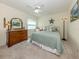 Comfortable bedroom featuring carpet, a ceiling fan, and beach-themed decor for a relaxing atmosphere at 4885 Tamarack Trl, Venice, FL 34293