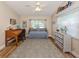 Inviting bedroom with wood floors, desk, and a cozy daybed area next to the window at 4885 Tamarack Trl, Venice, FL 34293