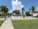 Community pool is surrounded by palm trees and plenty of seating at 4885 Tamarack Trl, Venice, FL 34293