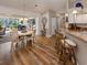 Cozy dining area with wood floors, stylish lighting, breakfast bar, and access to the outdoor patio at 4885 Tamarack Trl, Venice, FL 34293