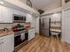 Well-lit kitchen with stainless steel appliances, granite counters, and lots of storage at 4885 Tamarack Trl, Venice, FL 34293