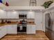 Bright kitchen with stainless steel appliances, granite countertops, and white cabinetry at 4885 Tamarack Trl, Venice, FL 34293