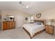 Comfortable bedroom featuring a ceiling fan, neutral walls, and a cozy bed with stylish furnishings at 4885 Tamarack Trl, Venice, FL 34293
