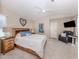 Bright main bedroom featuring a ceiling fan, neutral walls, and a cozy bed with stylish furnishings at 4885 Tamarack Trl, Venice, FL 34293