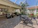 Screened-in patio with brick floors and outdoor seating, ideal for entertaining and relaxing at 4885 Tamarack Trl, Venice, FL 34293