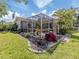 A screen enclosed patio surrounded by beautiful landscaping, offering a private outdoor space at 4885 Tamarack Trl, Venice, FL 34293