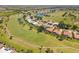 Aerial shot of the property situated on a golf course with ponds and landscaping at 511 Governors Green Dr, Venice, FL 34293