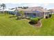 Manicured backyard featuring a screened-in pool and lush landscaping at 511 Governors Green Dr, Venice, FL 34293