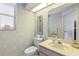 Cozy bathroom featuring decorative wallpaper and a neutral-toned vanity at 511 Governors Green Dr, Venice, FL 34293
