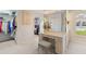 Bathroom vanity with stool and walk in closet at 511 Governors Green Dr, Venice, FL 34293
