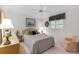 Bedroom with a ceiling fan, neutral toned walls, and a queen size bed with a patterned headboard at 511 Governors Green Dr, Venice, FL 34293