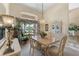 The cozy dining room has a large arched window with elegant floral curtains at 511 Governors Green Dr, Venice, FL 34293
