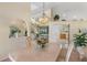 Open-concept dining room features a stylish chandelier and views of the pool area at 511 Governors Green Dr, Venice, FL 34293