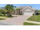 Beautiful home featuring a tile roof, two-car garage, and meticulously maintained landscaping at 511 Governors Green Dr, Venice, FL 34293
