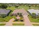 Stunning aerial view of a home with a beautiful tile roof, lush landscaping, and golf course views at 511 Governors Green Dr, Venice, FL 34293