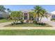 Inviting home exterior with palm trees and manicured flowerbeds at 511 Governors Green Dr, Venice, FL 34293