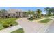 Beautifully landscaped front yard with a circular driveway and mature trees at 511 Governors Green Dr, Venice, FL 34293