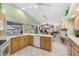 The kitchen features light wood cabinets, a ceiling fan, and views of the backyard at 511 Governors Green Dr, Venice, FL 34293