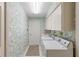 Laundry room with washer, dryer, cabinets, and wallpaper at 511 Governors Green Dr, Venice, FL 34293
