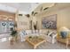 Inviting living room featuring a vaulted ceiling, neutral decor, and a view of the front entry at 511 Governors Green Dr, Venice, FL 34293