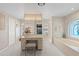 Elegant bathroom with a vanity, soaking tub, and decorative window at 511 Governors Green Dr, Venice, FL 34293
