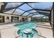 Relax in this private screened-in pool with adjacent spa and seating area at 511 Governors Green Dr, Venice, FL 34293