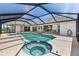 Outdoor pool and hot tub under a screened enclosure at 511 Governors Green Dr, Venice, FL 34293
