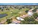 An aerial view of a property that is surrounded by a golf course and community at 542 Clubside Cir # 20, Venice, FL 34293