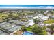 Community aerial shot featuring tennis courts, pools, golf course, a pond, and beautiful landscaping at 542 Clubside Cir # 20, Venice, FL 34293