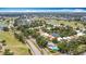Expansive aerial view of a community with a golf course, a pond, and beautiful landscaping at 542 Clubside Cir # 20, Venice, FL 34293