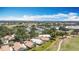 Aerial view showcasing a community with lush landscaping, tennis courts, walking paths, and surrounding golf courses at 542 Clubside Cir # 20, Venice, FL 34293