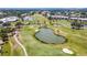 Overhead shot of well-maintained golf course with sand traps, water features, and surrounding community landscaping at 542 Clubside Cir # 20, Venice, FL 34293