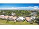 Beautiful aerial view showcasing lush landscaping and well-maintained homes in a serene community under a clear blue sky at 542 Clubside Cir # 20, Venice, FL 34293