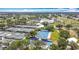 Aerial view featuring tennis courts, pools, and beautiful landscaping at 542 Clubside Cir # 20, Venice, FL 34293